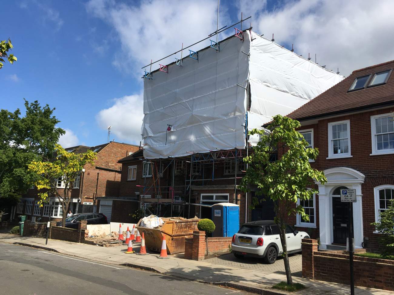 residential scaffolding covered with white sheet